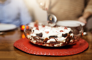 Pudding, dessert and dinner with party, celebration event with glass bowl, Christmas and lunch at home for holiday. Table setting, spoon and crockery for fine dining, December decoration and house