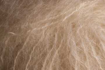 Beige natural woollen yarns with hairs. Textured background