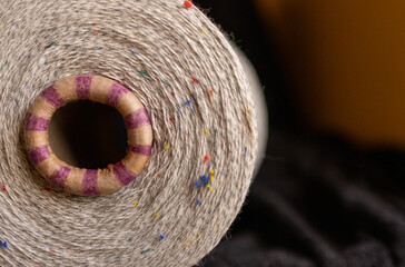 Macro view of natural yarn cone . Space for text .