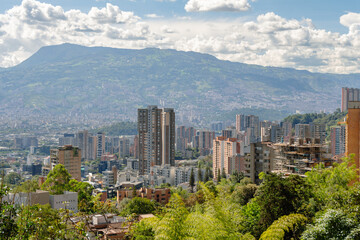 Obraz premium Beautiful panorama (cityscape) of Medellin, Medellín, on a sunny day. The pictures shows condominiums and the Andes Mountains. Antioquia, Colombia. Blue sky, white clouds.