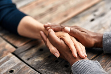 Holding hands, outdoor and support of people, table and kindness of love with respect, care and couple. Praying, compassion and patience of unity, together and commitment of marriage and empathy