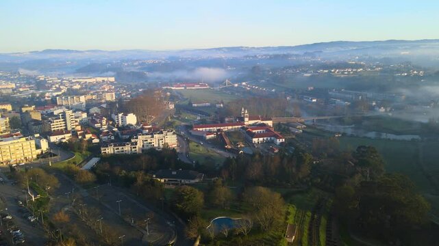 Stunning 4k drone footage of a Portugal city - Santo Tirso. View of the Abade Pedrosa Municipal Museum and the Monastery of St. Benedict (Sao Bento) with the Ave River in the background.