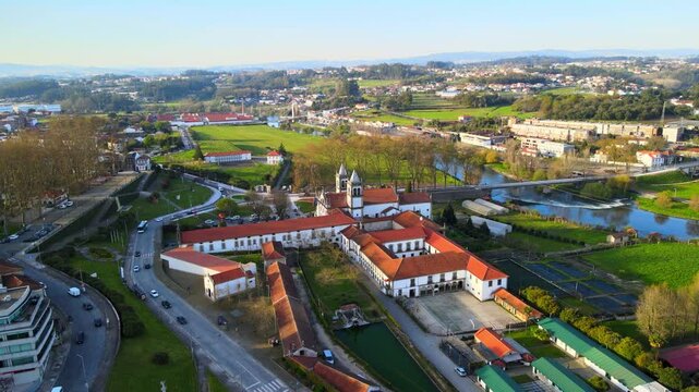 Stunning 4k drone footage of a Portugal city - Santo Tirso. View of the Abade Pedrosa Municipal Museum and the Monastery of St. Benedict (Sao Bento) with the Ave River in the background.