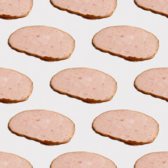 Seamless pattern with sliced Bologna sausage on white background.