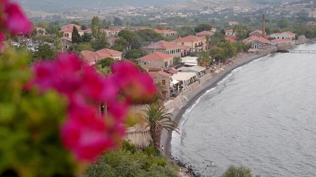 Aerial revealing of traditional Greece Lesvos island town seafront stone houses and landscape, Molyvos (Mithymna), Slow motion