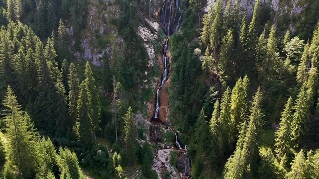 Cinematic aerial reveal of Cascada Cailor and the surrounding landscape of the Rodnei Mountains, Romania