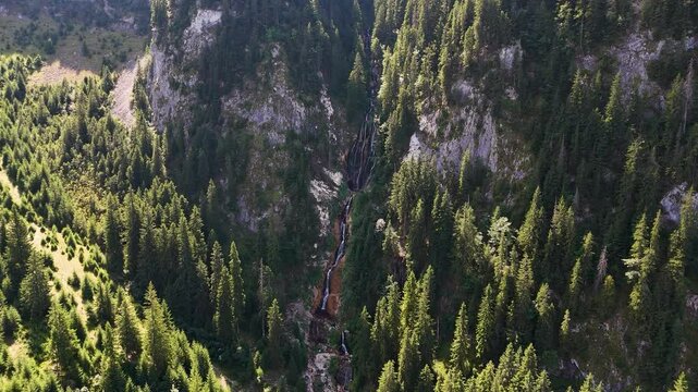 Helicopter POV of Cascada Cailor and the surrounding landscape of the Rodnei Mountains, Romania