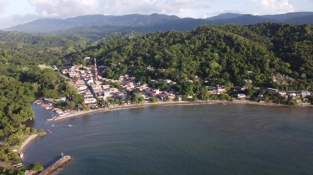The camera circles Chuspa, offering a stunning aerial view of this charming Caribbean town. The white-sand beaches, colorful houses, and palm trees create a postcard-perfect scene