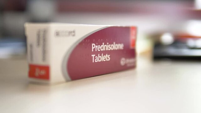 Close-up of Prednisolone tablets on a desk, commonly used to treat a wide range of health issues including allergies, blood disorders, skin diseases, inflammation, and infections