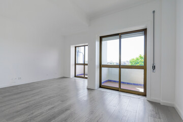 Empty new living room with two balconies facing the street with glass sliding doors