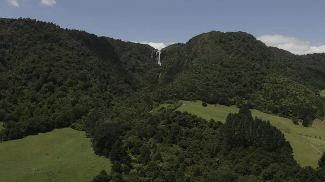Great hike. Great weather. Aerial view of an unpretentious waterfall in the middle of some farmland.