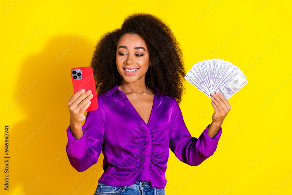 Canvas Prints Photo portrait of pretty young girl hold device money fan wear trendy violet outfit isolated on yellow color background