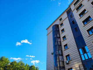 Fototapeta premium Beautiful facade of houses blue sky and white clouds on a bright sunny day