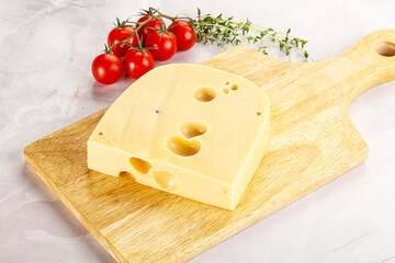 Maasdam cheese brick over board