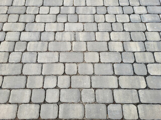 Perspective grey paving slabs stretching into the distance.