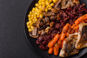 A colorful vegetarian dish consists of fish, beans, corn, mushrooms