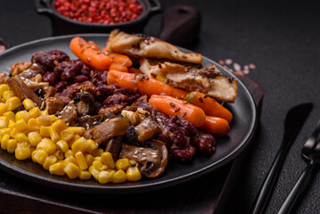 A colorful vegetarian dish consists of fish, beans, corn, mushrooms
