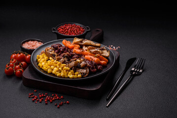 A colorful vegetarian dish consists of fish, beans, corn, mushrooms