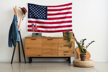 USA flag and wooden chest of drawers in interior of living room