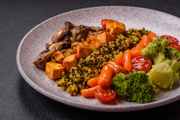 Colorful vegan vegetarian dish consists of tofu, broccoli, quinoa, mushrooms