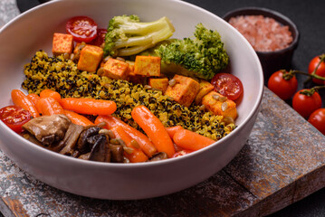 Colorful vegan vegetarian dish consists of tofu, broccoli, quinoa, mushrooms