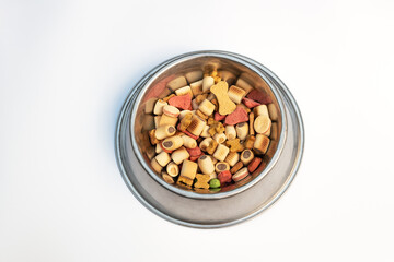 Dry dog food. Biscuit bones and crunchy organic kibble pieces for dog feed. Dog treats. Healthy dry pet food for dogs. Dry pets food. Brown crunchy kibble pieces for pets feed heap isolated on white b