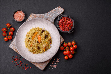 Delicious fresh pilaf with rice, carrots, meat, onions, spices and berries
