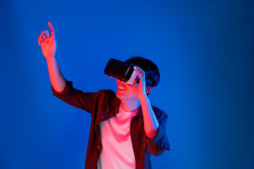 Smart Asian man looking through VR glasses turn to metaverse pointing slide research folder data with touchscreen in futuristic technology analyzing innovation interface 3D hologram meta. Contrivance.