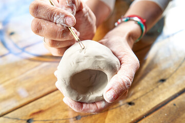 shape clay with hands