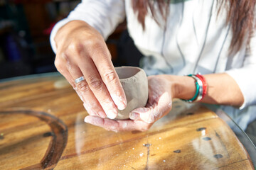 shape clay with hands