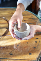 shape clay with hands