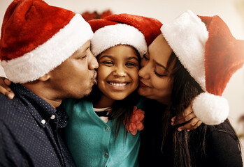Family, Christmas portrait and home kiss for festive holiday, kid learning tradition and love. Parents, daughter and xmas party hats for December event, support and embrace for celebration in lounge