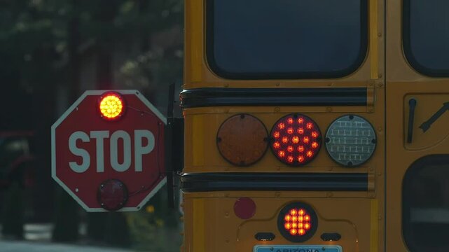 A school bus stop sign while picking up students at a bus stop
