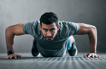 Fototapeta premium Asian man, portrait and push up in gym for fitness, strong muscle development and intensity workout. Male person, core and confident in exercise routine at club, training challenge and bodybuilder
