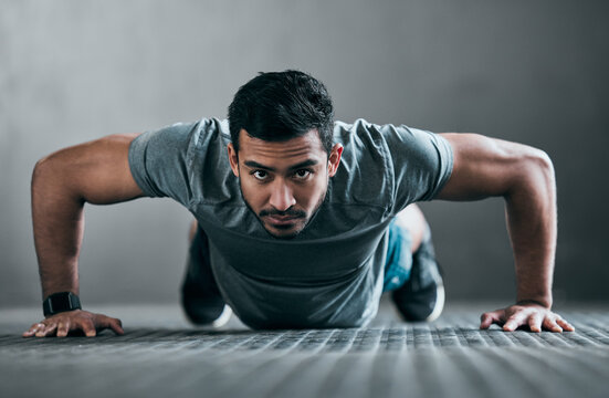 Asian man, portrait and push up in gym for fitness, strong muscle development and intensity workout. Male person, core and confident in exercise routine at club, training challenge and bodybuilder