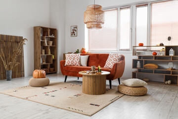 Interior of living room with autumn decor, sofa and table