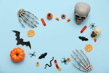 Frame made of different decorations and sweets for Halloween on color background