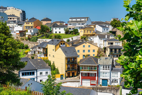 Colorful houses on the mountainside next to the sea coast in the village of Ribadeo, Galicia.