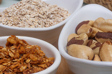 several bowls filled with chestnuts, oats and granola