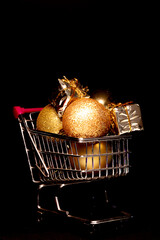 supermarket cart full of golden balls and christmas gifts