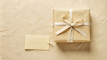 A flat lay of a beautifully wrapped gift with a ribbon and a handwritten note