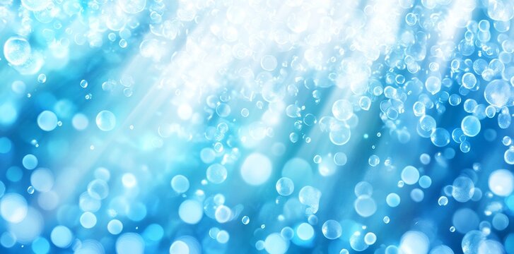The abstract background blue bokeh is beautiful bright light glitter sparkles on a soft color background. It could be used for advertisements, cosmetics, banners, and posters and can also be used to