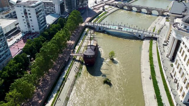 A captivating drone video of Skopje, Macedonia, showcasing the city's unique blend of historic and modern architecture, and the scenic Vardar River, highlighting the vibrant atmosphere