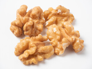 close-up of shelled walnuts on a white background. Food that's good for your mind