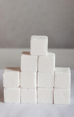 The sugar lumps lie on a white surface, with a copy space for the text