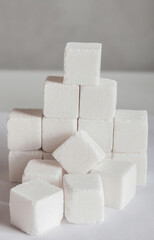 The sugar lumps lie on a white surface, with a copy space for the text