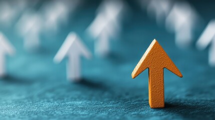 A golden arrow leading a group of white arrows on a teal textured surface, representing leadership, direction, and achieving goals through clear and decisive actions.