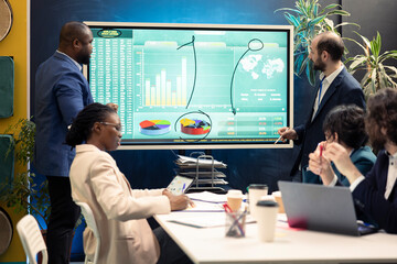 Account executive team examining trends to help make important decisions to corelate with enterprise objectives. Corporate affiliates working together to meet project deadline.