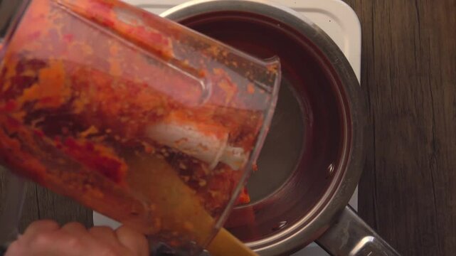 Top view of a pan in which hot chili sauce is stewed. High quality 4k footage