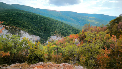 View of the high mountains banner with rocks on the foreground fall autumn. Mountain valley, beige stones, foggy mountains landscape, blue sky, freedom, nature, travel background, journey, meditation